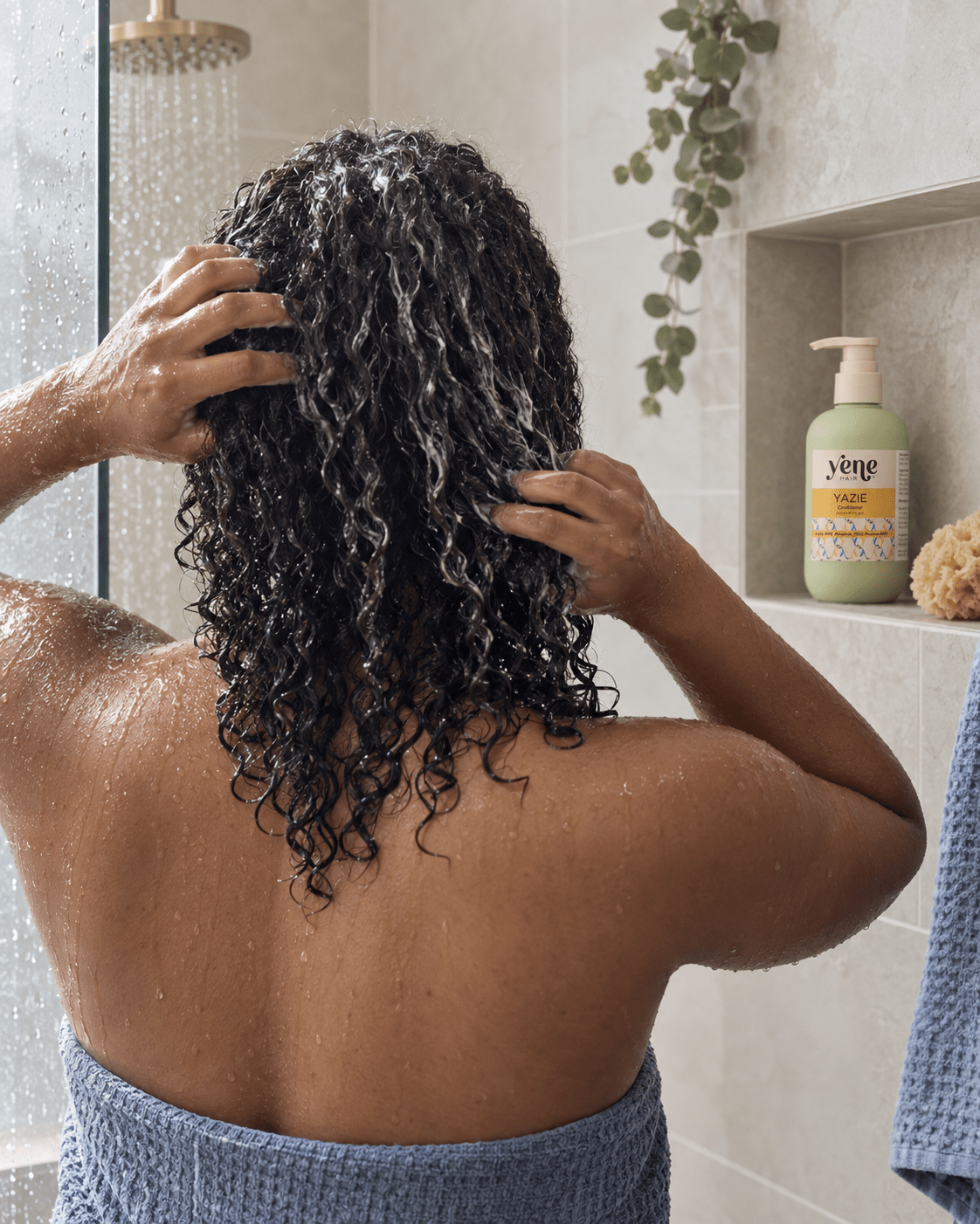 Woman with wet curly hair using Yazie Conditioner by Yene Hair in the shower