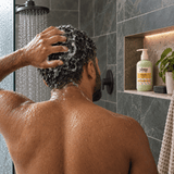 Woman working Yazie Conditioner through wet curly hair in the shower