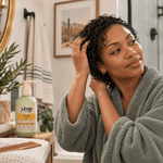 Woman with short wet curly hair holding Yazie Conditioner by Yene Hair during her wash-day routine