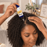 Woman applying Yazie Hair Oil by Yene Hair directly to her scalp during a hair-care routine